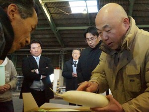 査定品を確認する生産者と市場担当者