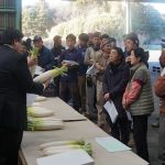 生産者に呼び掛ける市場担当者(1月30日)
